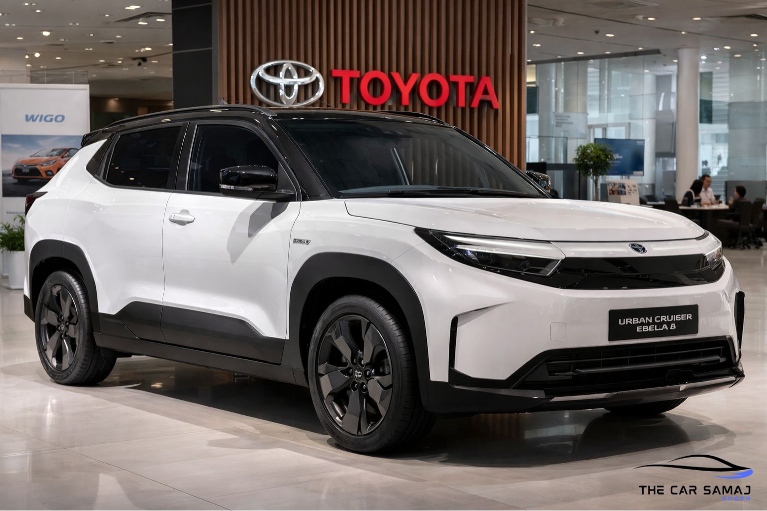 Toyota Urban Cruiser Ebella electric SUV showcased in a modern Toyota showroom, white color EV with LED headlights, black alloy wheels and premium electric SUV design