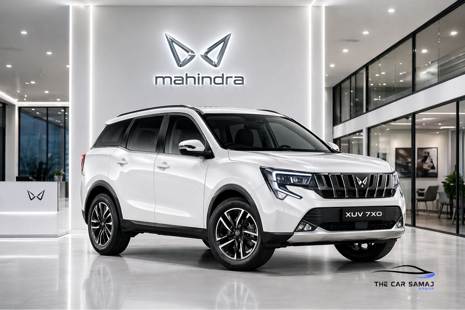 Pearl white Mahindra XUV 7XO SUV showcased in a modern premium showroom with bright white lighting, glossy floor reflections, and illuminated Mahindra logo in the background.